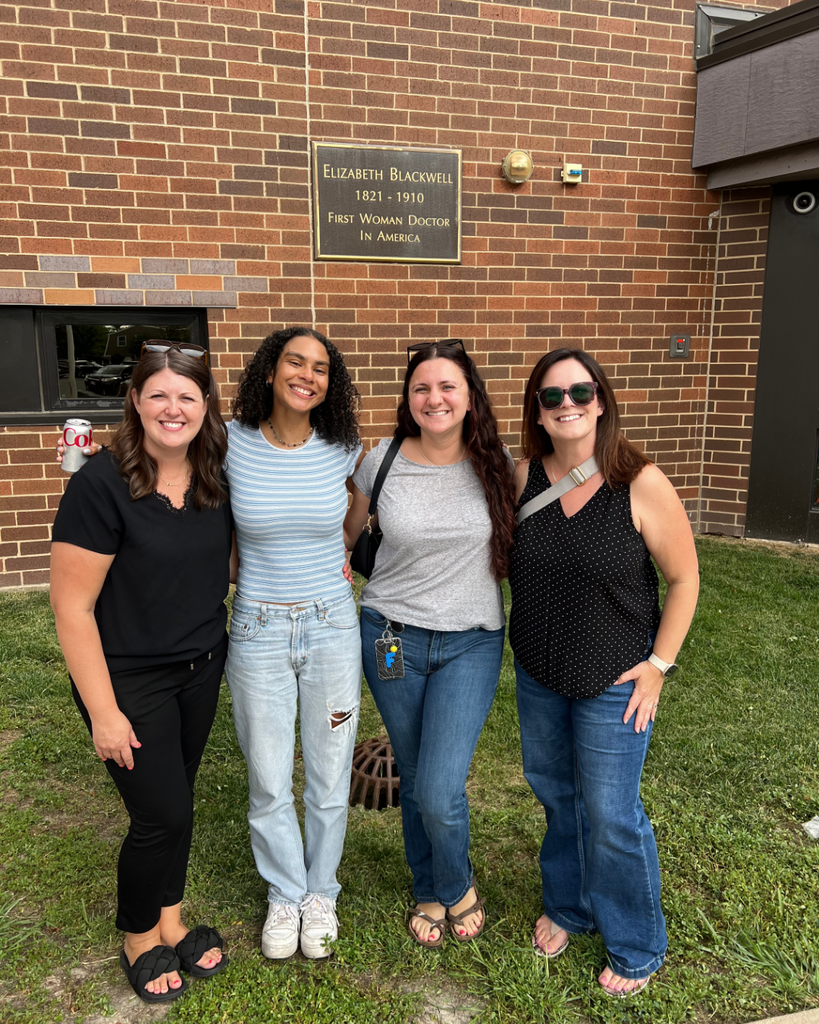 Blackwell staff and their families visiting together while enjoying BBQ foods