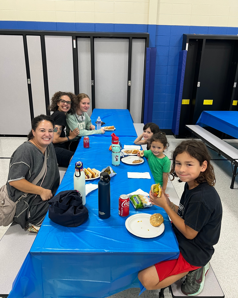 Blackwell staff and their families visiting together while enjoying BBQ foods