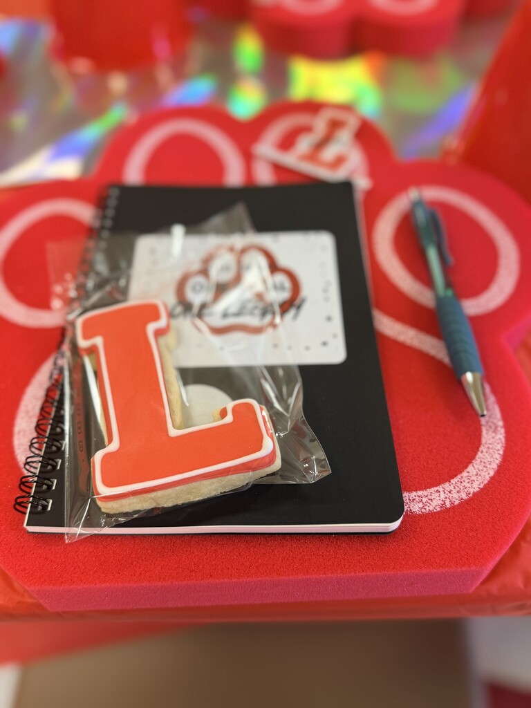 Teacher materials with cookie, notebook, and pen