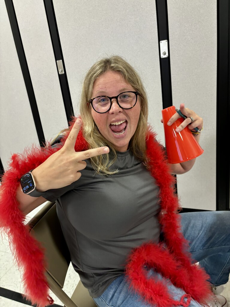 Teacher holding up peace sign
