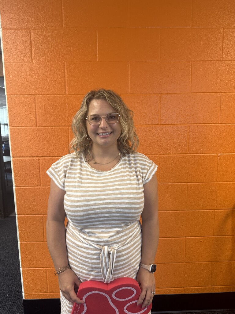Women smiling at orange wall