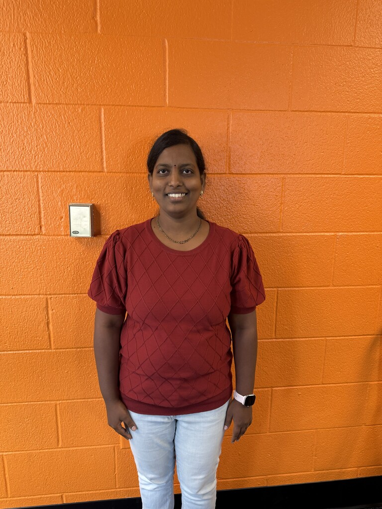 Woman smiling by orange wall
