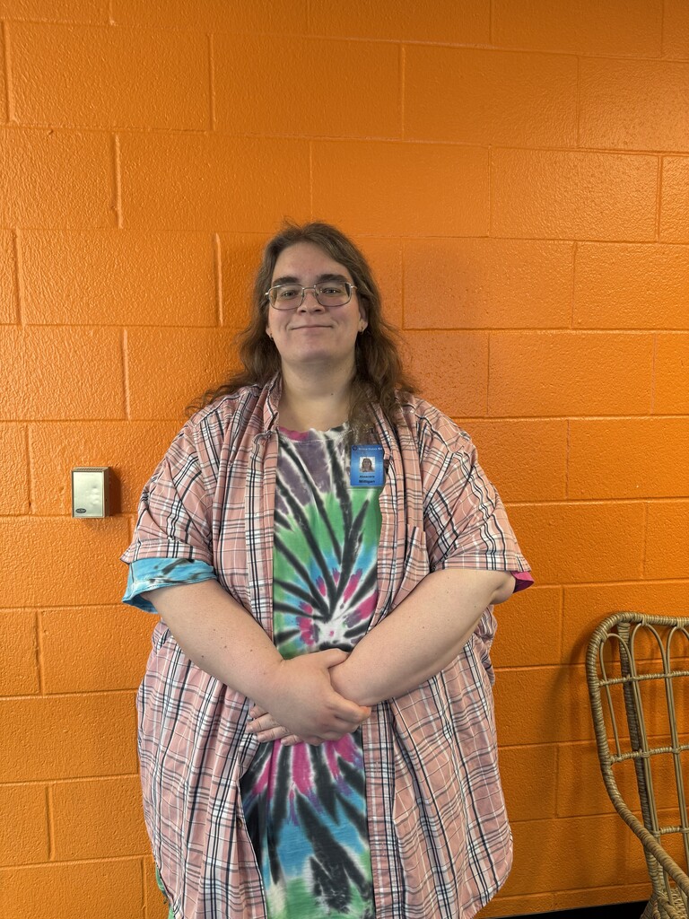 Woman smiling by orange wall