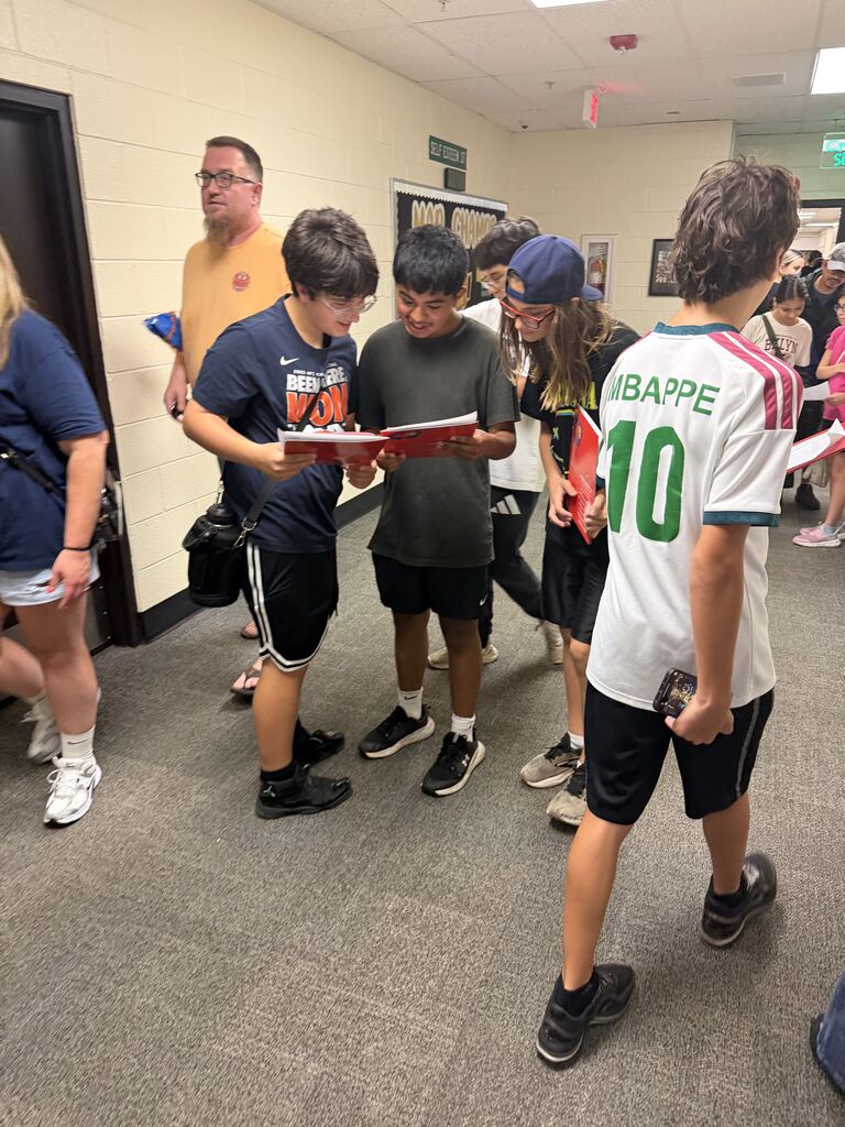 three students looking at their schedule