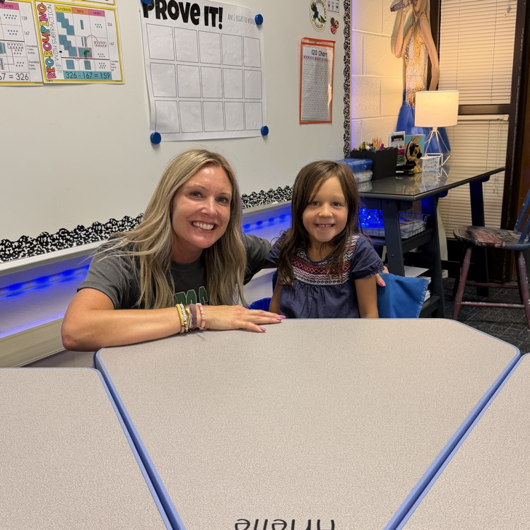 Mrs. Ernsting with a student at her desk.