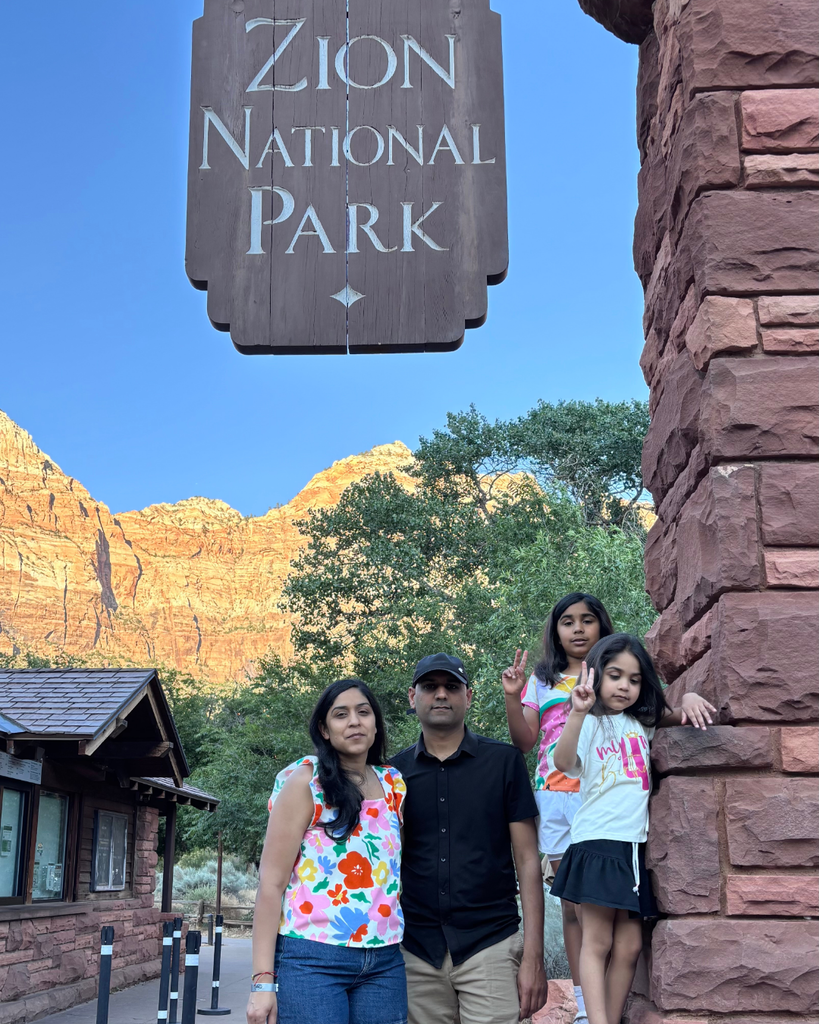 Family in front of Zion National Park sign
