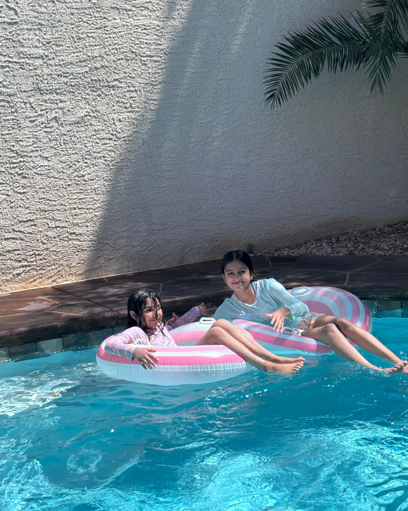 Family swimming in pool