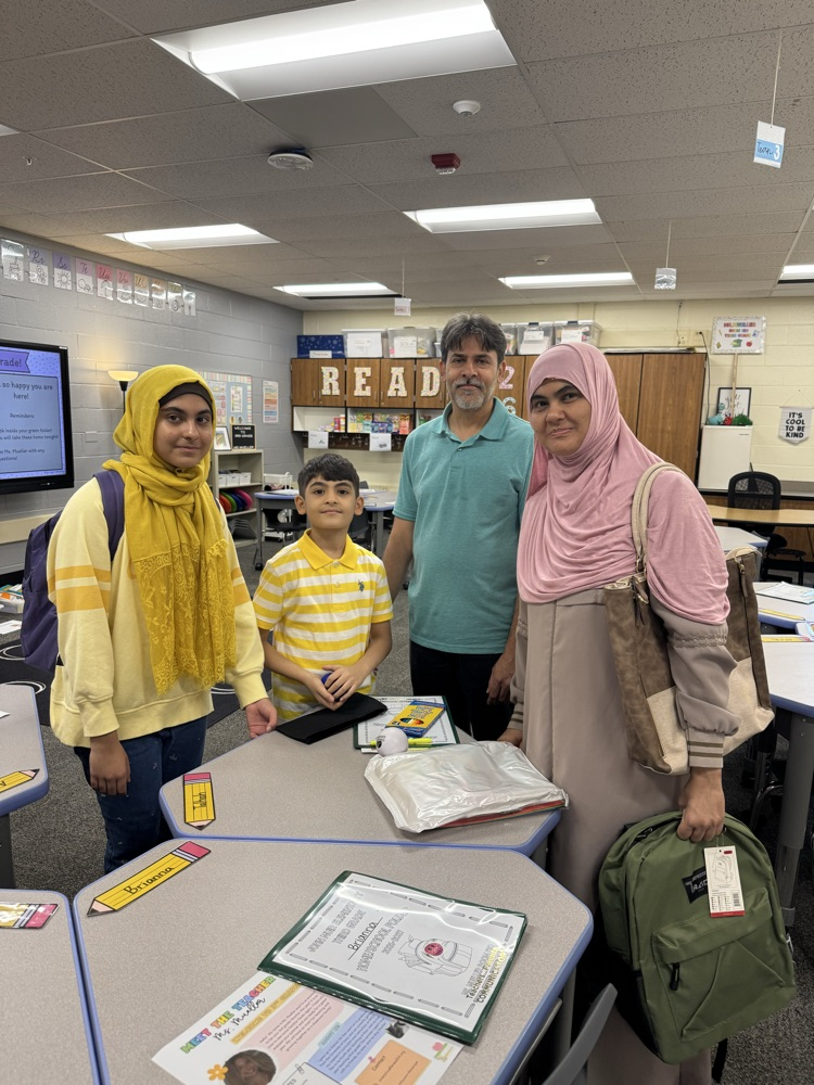 a family standing in a classroom