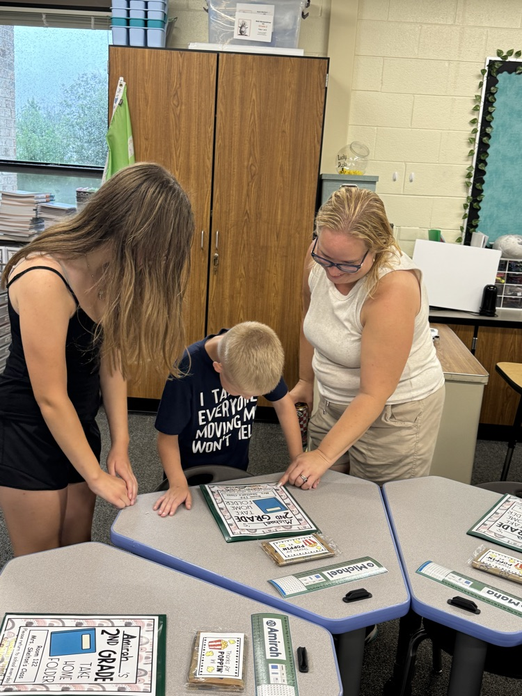 family reading papers on a student desk