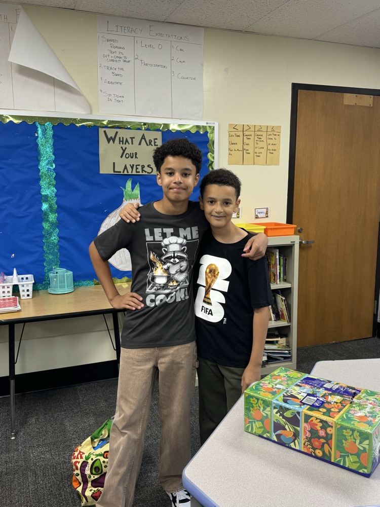 two boys smiling in a classroom