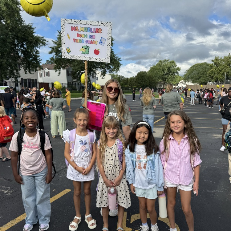 teacher and students standing in parking lot on first day
