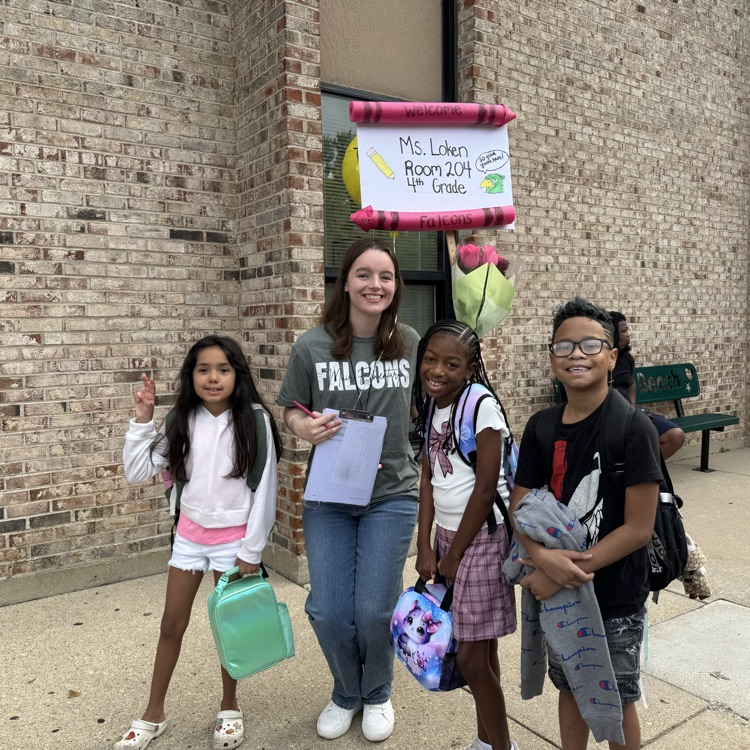 teacher and students standing together on first day of school