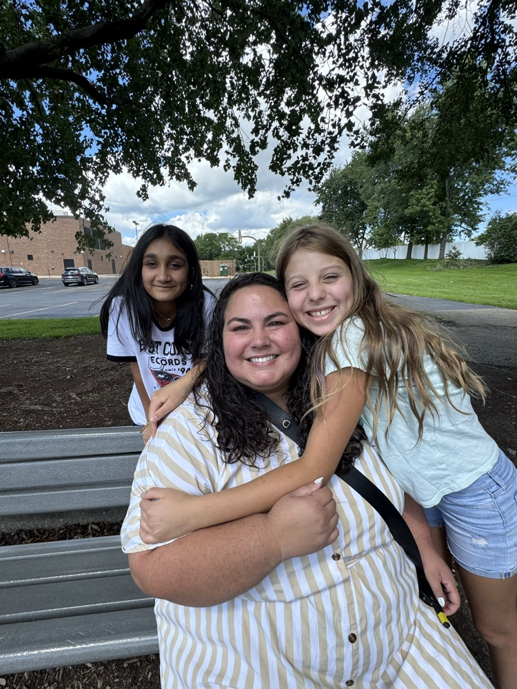 Miss. Menconi and student giving her a hug.