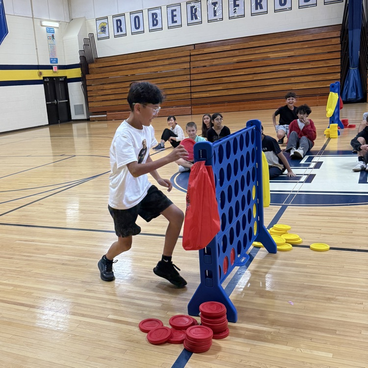 boy in gyms playing connect four