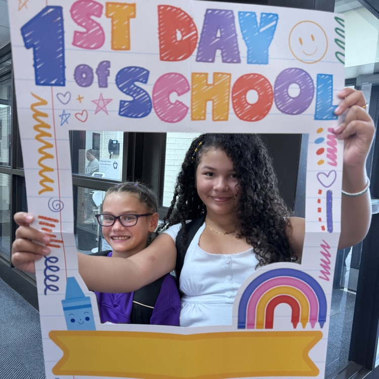 Sixth grade students posing in a 1st Day of School frame