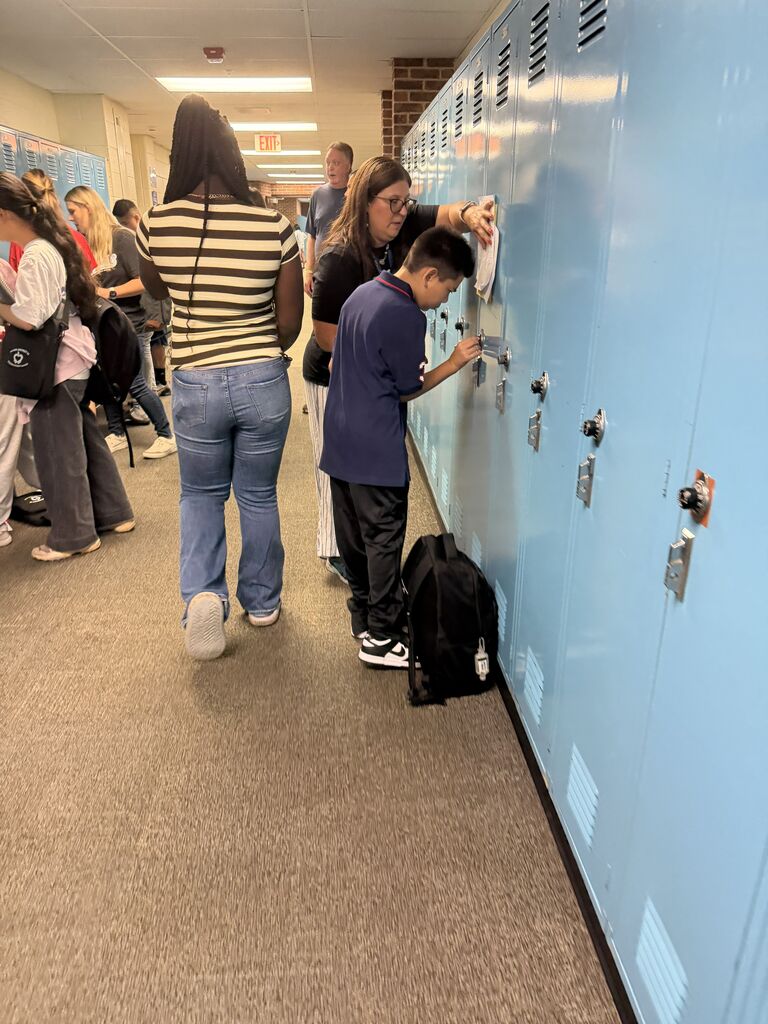 students on the first day of school opening their locker