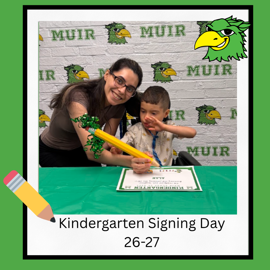 Student with parent signing paper with giant pencil.