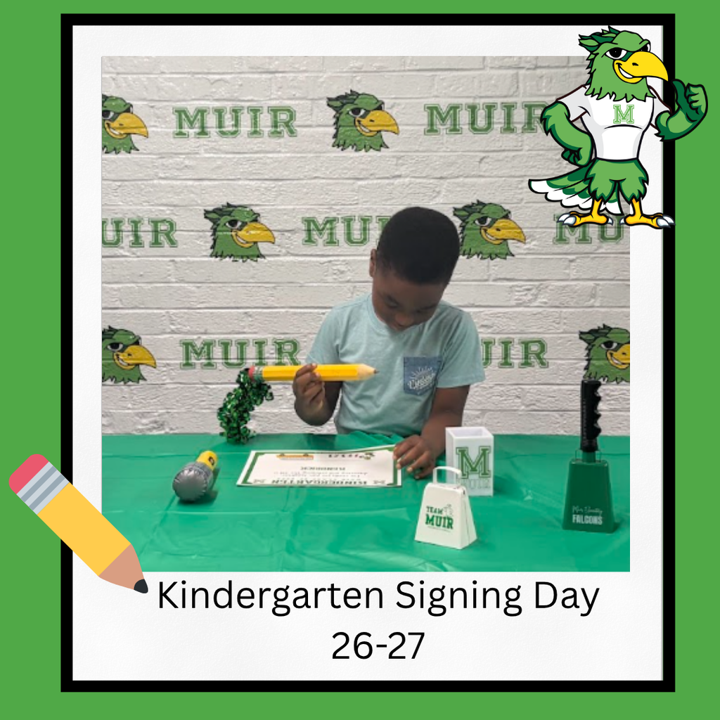 Student signing a paper with a giant pencil.