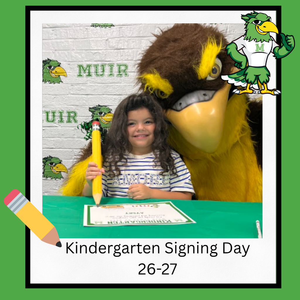 Student signing a paper with large pencil with a falcon.