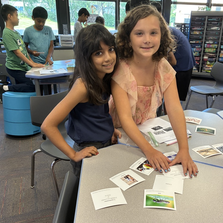 two girls sorting objects by size 