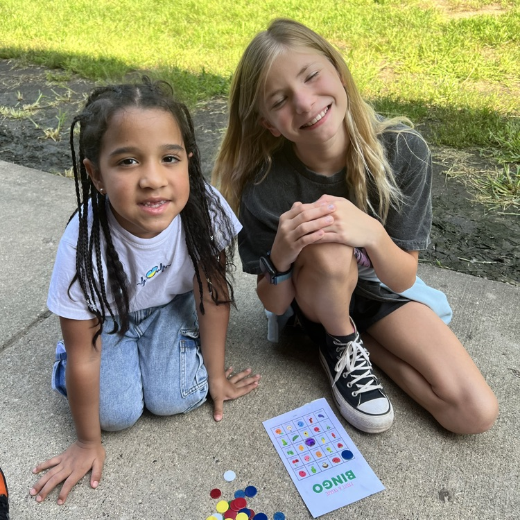 Students playing bingo outside on harvest day.