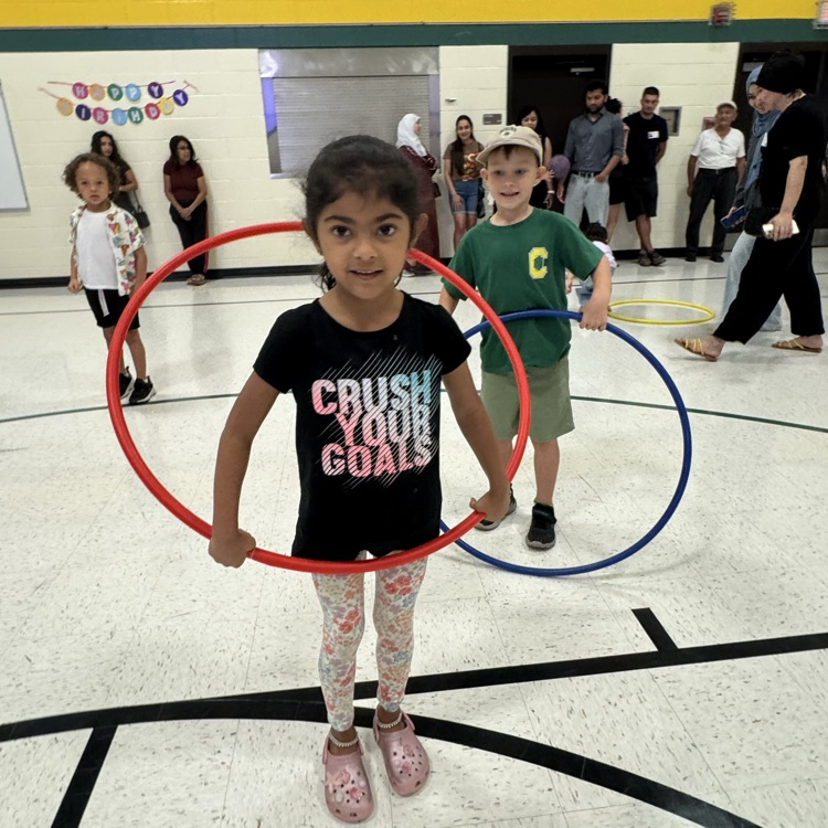 Future kindergarteners playing with hula-hoops in the gym.