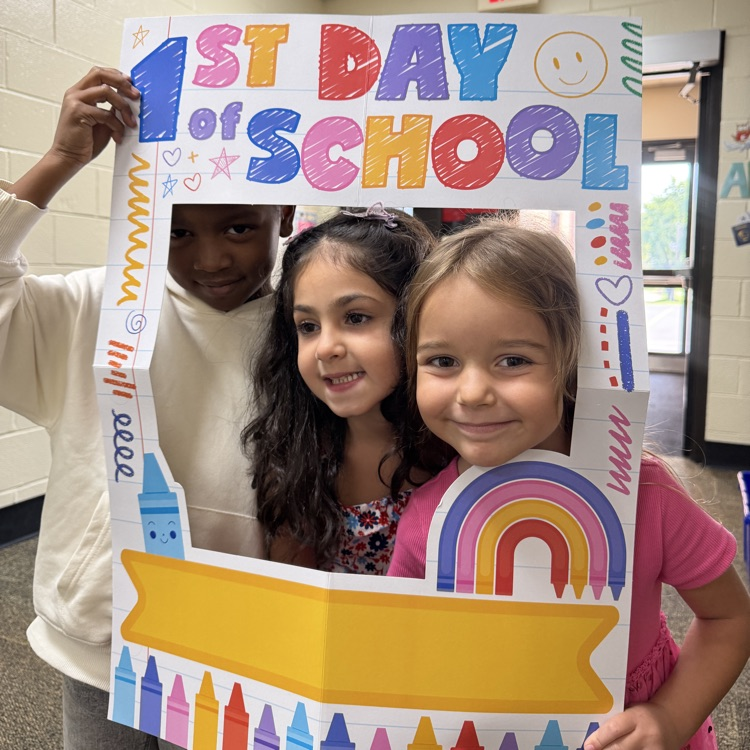 Kindergarten students posing in a 1st day of school frame 