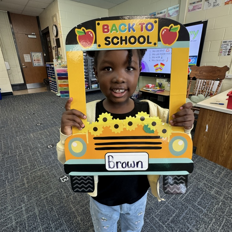 Kinder with a back to school sign.