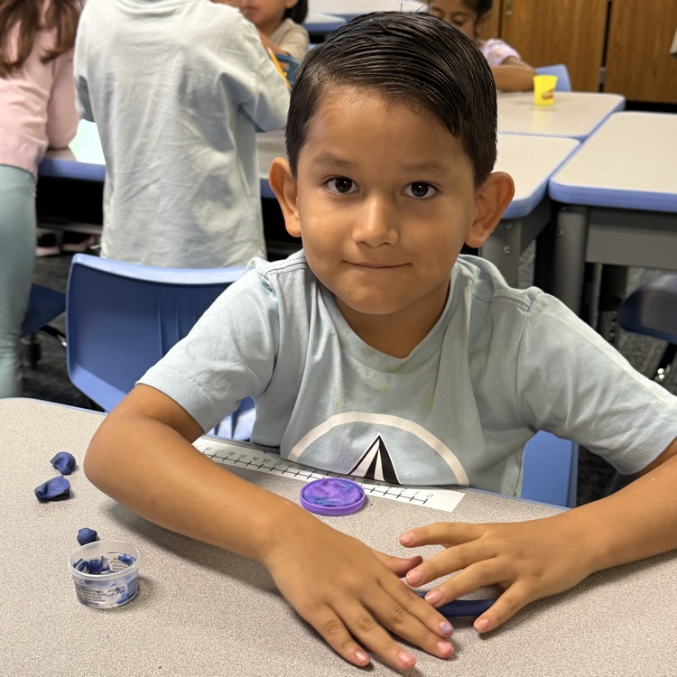 A happy Kinder at his desk.