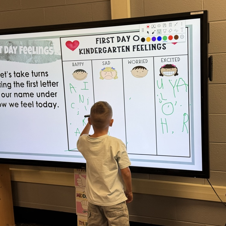 Student using the board showing how he felt on the first day of school.