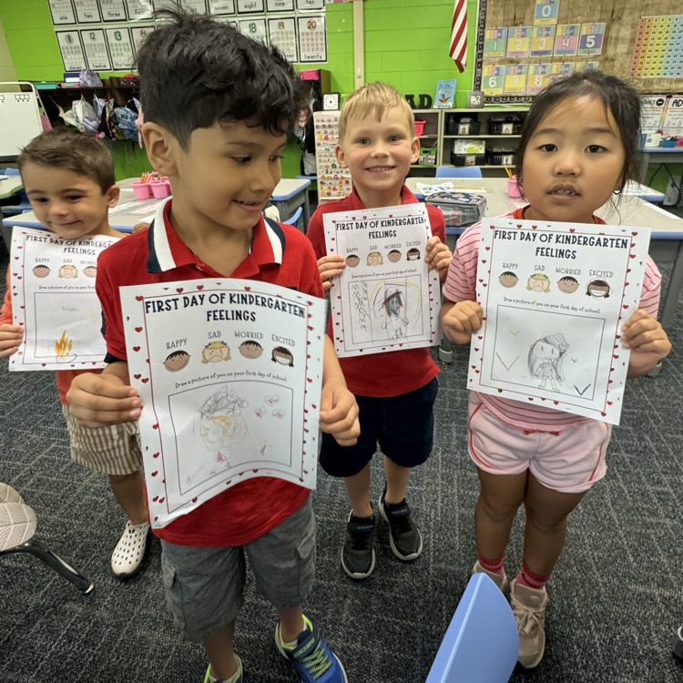 Group of kinders showing their work.
