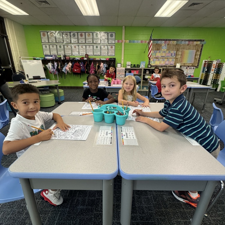 Group of kinders working at their desk.