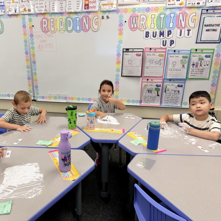 Kids writing numbers in shaving cream
