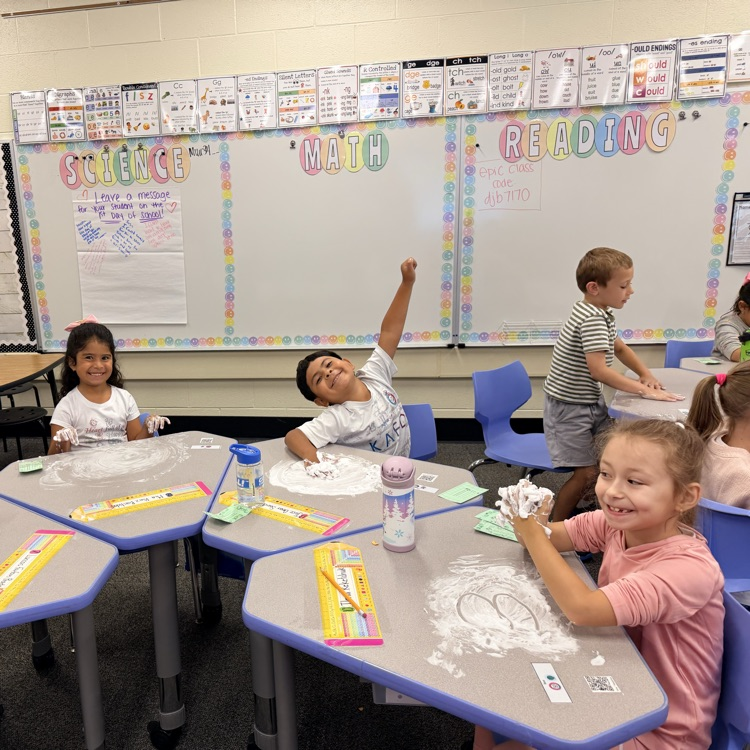 Kids writing numbers in shaving cream