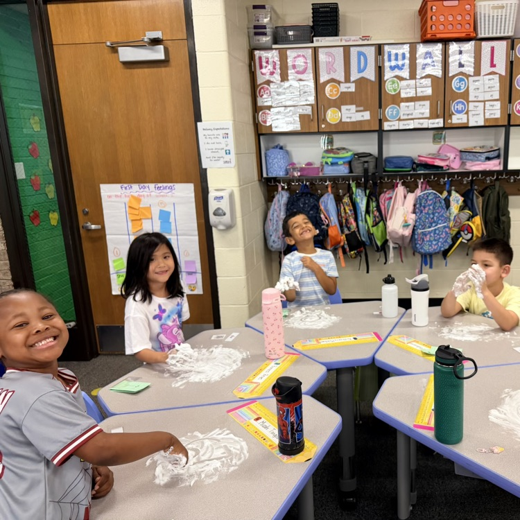 Kids writing numbers in shaving cream
