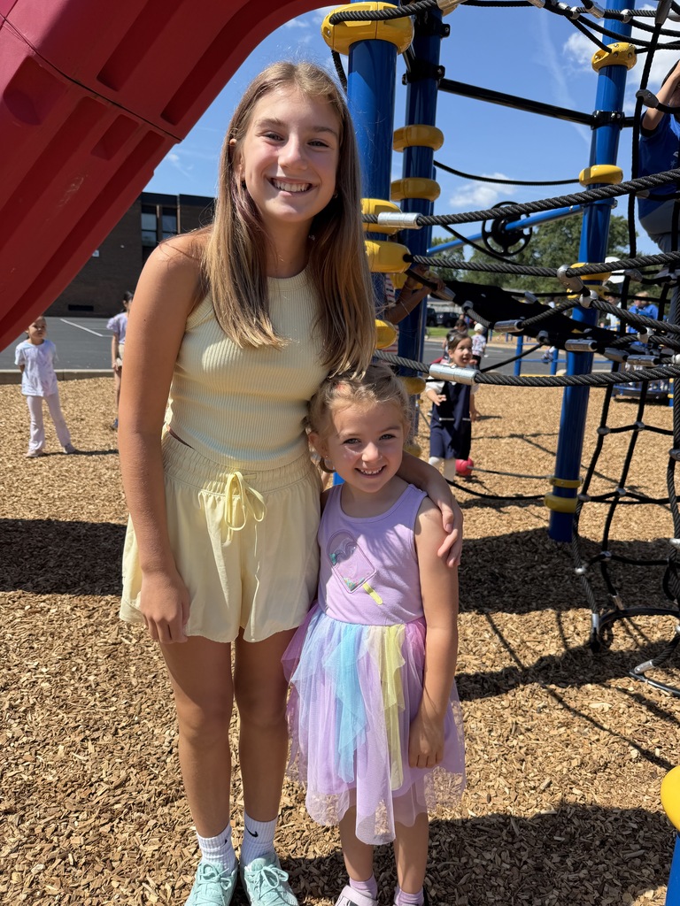 Two siblings smiling