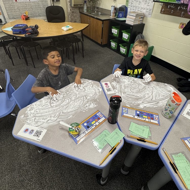 kids writing numbers in shaving cream