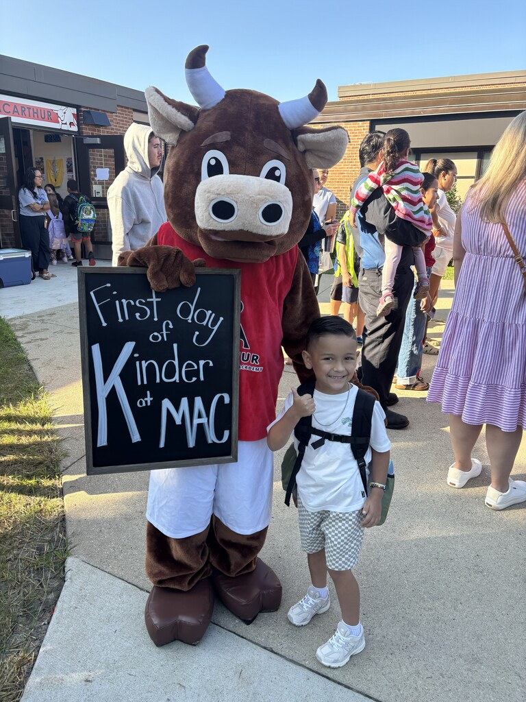 Boy stands with Bullseye, the mascot