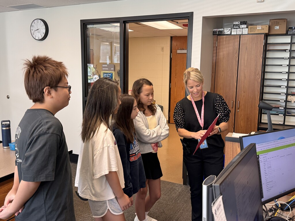 Mrs. Belt and students at announcements