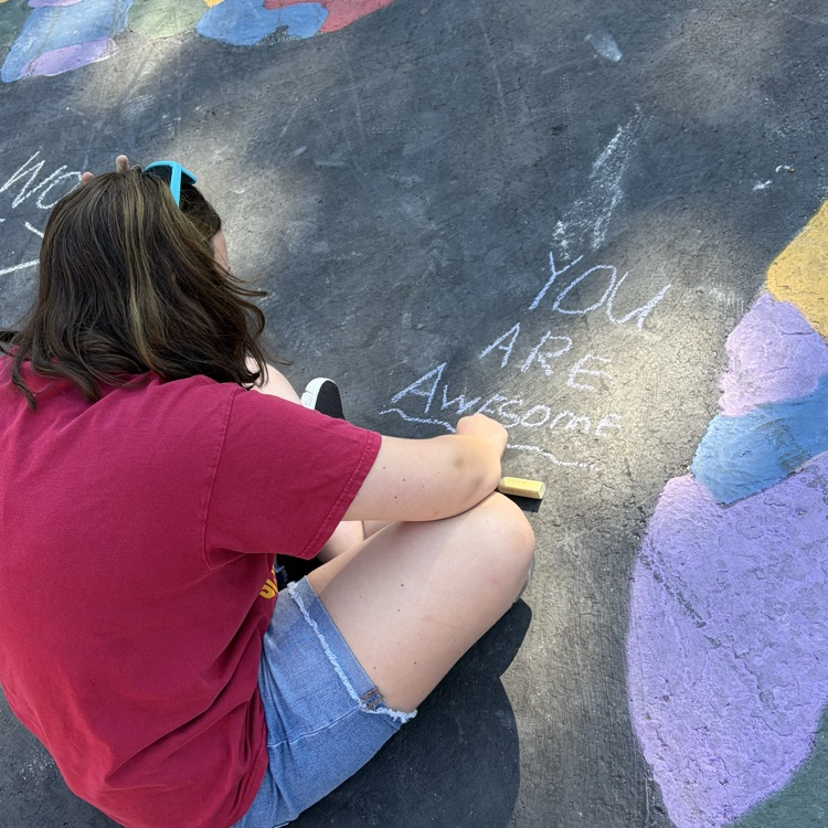 student writing you are awesome in chalk