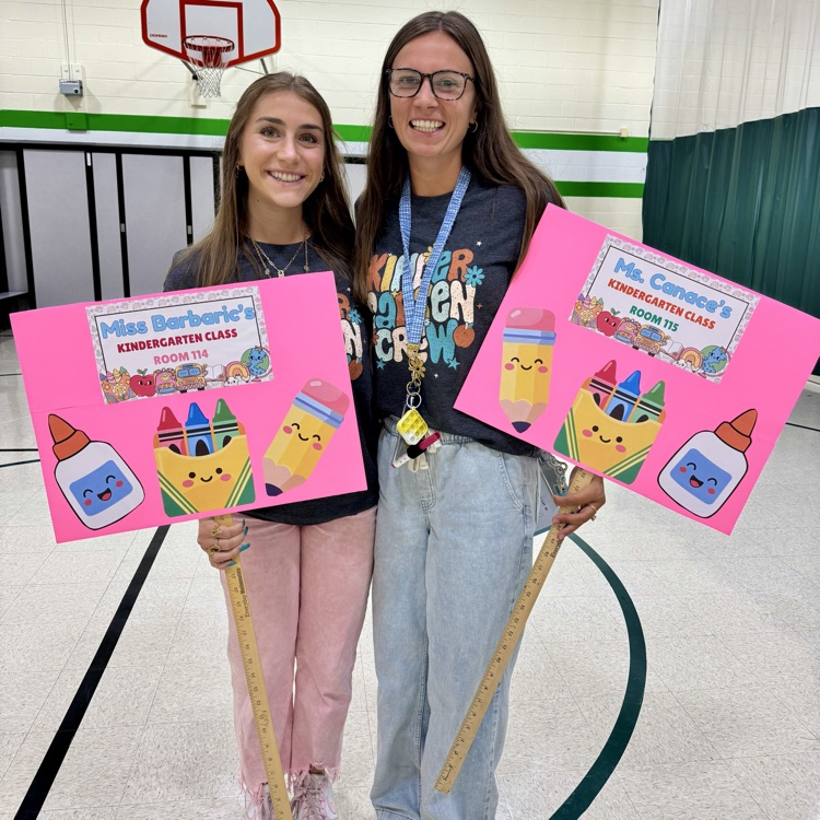 two teachers holding welcome signs
