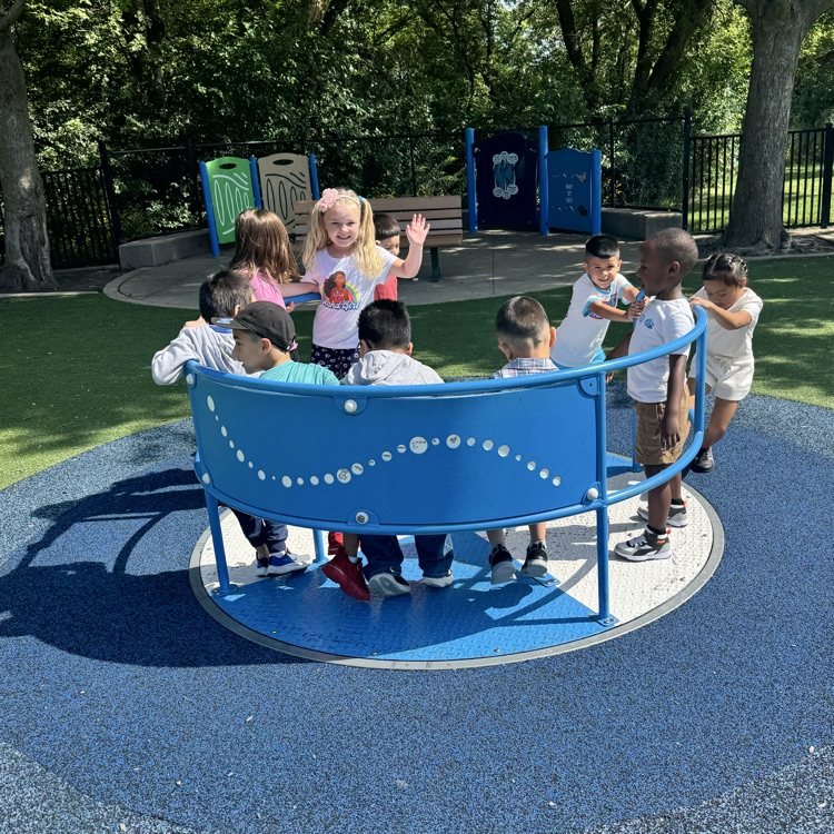 students on a playground merry-go-round