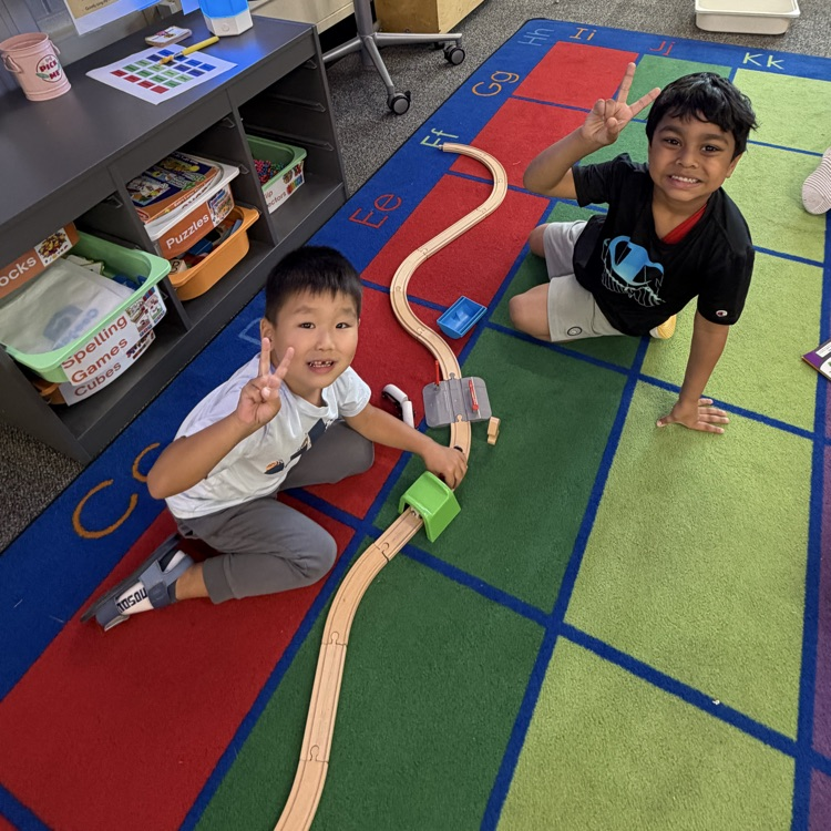 students building a wooden train set