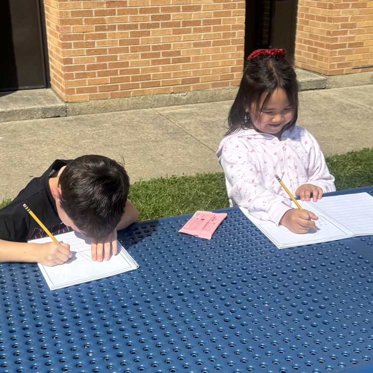 two students working on a writing assignment