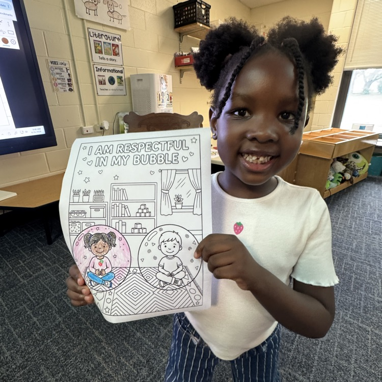Kindergartener showing her work.
