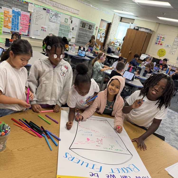 students writing on a poster