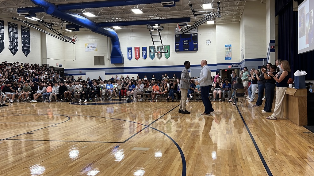 a speaker shaking the hand of a school principal