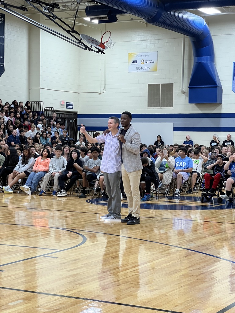 a speaker and a teacher at a school assembly