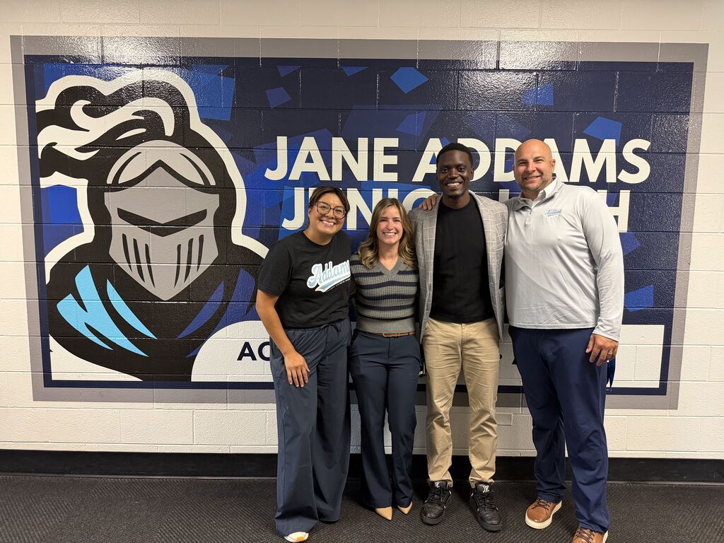 staff members with a guest speaker