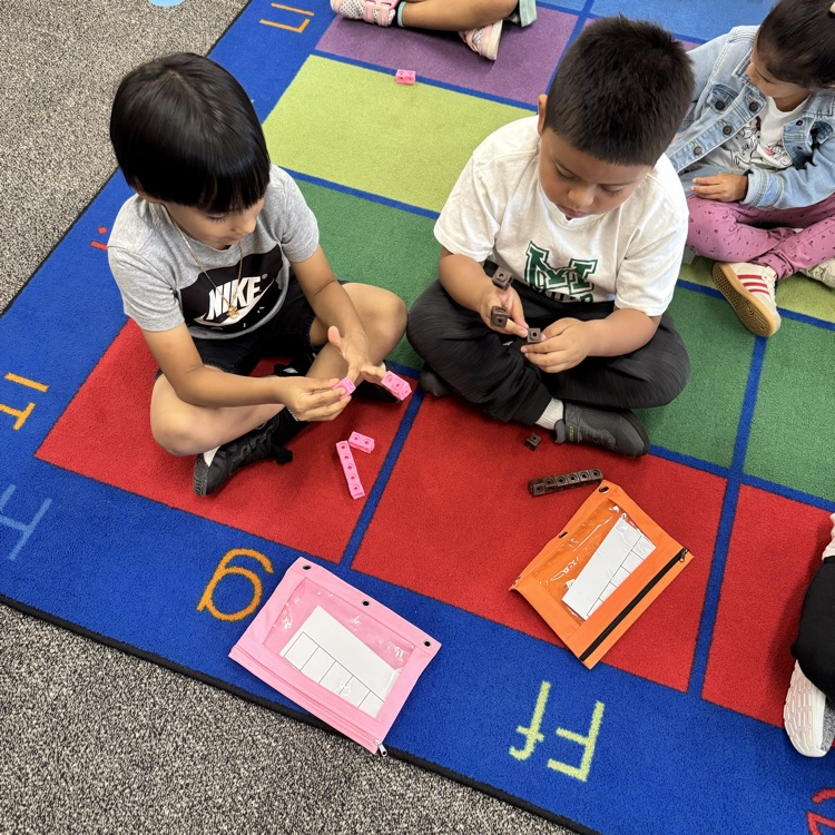 students showing quantity with blocks